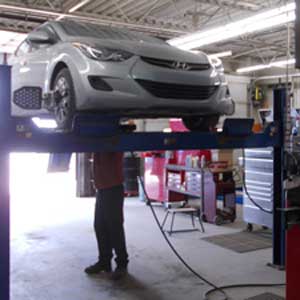 Man working on wheel alignment